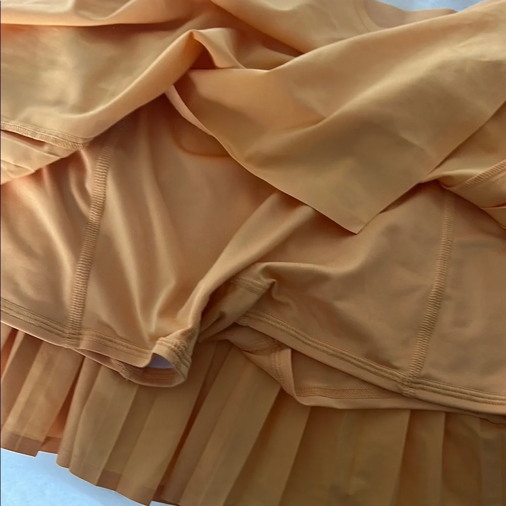 ALO Yoga Pleated Mini Skirt in Peach Orange